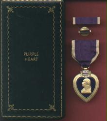 Genuine WWII Purple Heart medal in case with ribbon bar and lp